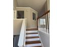 Elegant staircase with wooden steps and white railings leading to the upper level at 10561 Aspenwood Ct, Jonesboro, GA 30238