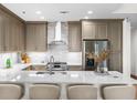 Modern kitchen with stainless steel appliances, a range hood, and a large island with seating at 270 17Th Nw St # 1608, Atlanta, GA 30363
