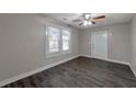 Spacious living area with dark floors and ceiling fan, access to backyard at 1333 Womack Ave, Atlanta, GA 30344