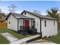 Newly renovated white house with red door and black accents at 951 Reed Ave, Atlanta, GA 30344