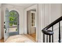 Foyer view showcasing the open door, hardwood floors, and elegant architectural details at 2522 Habersham Nw Rd, Atlanta, GA 30305