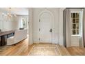 Elegant foyer featuring hardwood floors, arched doorway, chandelier, and view into the dining room at 2522 Habersham Nw Rd, Atlanta, GA 30305