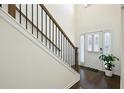 Bright entryway with hardwood floors and staircase with metal railing at 13136 Vista Ln, Covington, GA 30014