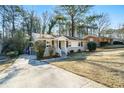 Brick ranch home with driveway, mature trees, and grassy yard at 3218 Ward Sw Dr, Atlanta, GA 30354