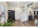 Welcoming entryway with wood floors, coat rack, and staircase leading to the upper level at 251 Ivy Chase Loop, Dallas, GA 30157