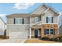 Charming two-story home with a mix of stone and siding, complemented by dark shutters and a well-manicured lawn at 251 Ivy Chase Loop, Dallas, GA 30157