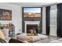 Elegant living room with a fireplace, dark curtains, and a modern entertainment center at 251 Ivy Chase Loop, Dallas, GA 30157