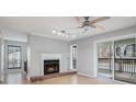 Living room with a fireplace, fan, and sliding glass doors to a balcony at 2901 Lenox Ne Rd # 506, Atlanta, GA 30324