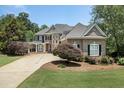 Two-story home with a brick facade and lush landscaping at 1211 Grand View Se Dr, Mableton, GA 30126