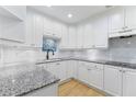 Spacious kitchen with white cabinets and granite countertops at 211 Colonial Homes Nw Dr # 1105, Atlanta, GA 30309