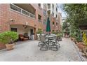 A charming patio area with an outdoor table and chairs, surrounded by potted plants at 211 Colonial Homes Nw Dr # 1105, Atlanta, GA 30309