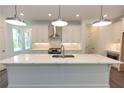 Large kitchen island with white cabinets and stunning quartz countertops at 536 Sawnee Village Blvd # D66, Cumming, GA 30040