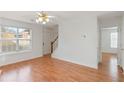 Bright living room with hardwood floors, ceiling fan, and sun-filled window at 6118 Dorsett St, Douglasville, GA 30134