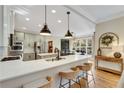 Modern kitchen featuring white quartz countertops and stainless steel appliances at 6229 Grand Loop Rd, Sugar Hill, GA 30518