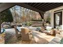 Covered patio with dining and seating areas at 6229 Grand Loop Rd, Sugar Hill, GA 30518