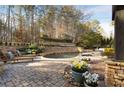 Landscaped backyard with a large, inviting pool and stone retaining walls at 6229 Grand Loop Rd, Sugar Hill, GA 30518