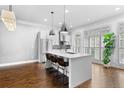 Bright kitchen featuring white cabinets, stainless steel appliances, and hardwood floors at 818 Highland Green Ne Way # 818, Atlanta, GA 30306