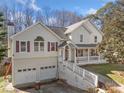 The front exterior of the home featuring a two-car garage and covered porch at 232 Taylors Farm Dr, Canton, GA 30115
