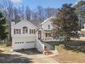 View of the home exterior showcasing the two-car garage and landscaping at 232 Taylors Farm Dr, Canton, GA 30115