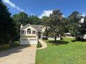 Inviting home with well-manicured lawn and mature tree in the front yard, featuring a two car garage at 232 Taylors Farm Dr, Canton, GA 30115