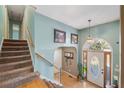 Welcoming foyer with staircase, hardwood floors, and a decorative front door with beautiful glass and side lights at 232 Taylors Farm Dr, Canton, GA 30115