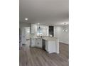 Modern kitchen with white cabinets, stainless steel appliances, and an island at 235 Prestwyck Oak, Lawrenceville, GA 30043