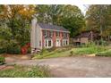 Two-story house with a red brick facade and a side driveway at 4698 Norman Nw Dr, Kennesaw, GA 30144