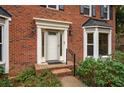 Inviting front entrance with a brick facade and a white door at 4698 Norman Nw Dr, Kennesaw, GA 30144