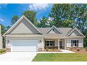 New home with gray siding, stone accents, and a 2-car garage at 459 Benson Meadows Dr, Dallas, GA 30157