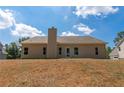 Tan house with a sloped backyard and chimney at 459 Benson Meadows Dr, Dallas, GA 30157