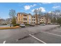 Exterior of the apartment building with ample parking spaces available for residents and visitors at 533 Bentley Pl, Tucker, GA 30084