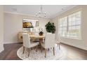 Elegant dining room featuring a round wooden table and neutral decor at 6850 Canyon Creek Way, Cumming, GA 30028