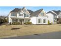 Two-story house with white siding, gray shutters, and a stone accent at 6850 Canyon Creek Way, Cumming, GA 30028