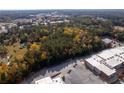 Aerial view showing wooded lot and adjacent buildings at 157 New Hope Rd, Fayetteville, GA 30214