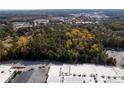 Aerial view of a wooded lot with nearby businesses at 157 New Hope Rd, Fayetteville, GA 30214