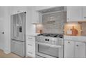 Stainless steel appliances and designer backsplash highlight this kitchen at 332 Sugarview Rd # 16, Sugar Hill, GA 30518