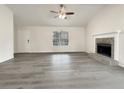 Spacious living room with gray vinyl flooring and a stone fireplace at 108 Ridgefield Dr, Douglasville, GA 30134