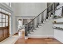 Grand staircase with dark wood railing and hardwood floors at 3350 Vista Creek Dr, Dacula, GA 30019