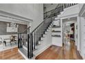 Grand staircase with dark wood railing and hardwood floors at 3350 Vista Creek Dr, Dacula, GA 30019