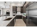 Sleek kitchen with dark cabinetry and stainless steel appliances at 40 12Th Ne St # 1004, Atlanta, GA 30309