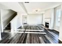 Bright and airy living room with hardwood floors and fireplace at 576 Rodeo Dr, Auburn, GA 30011