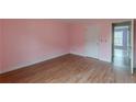 Empty bedroom with pink walls and wood flooring at 601 Rangeley Meadows Ct, Hampton, GA 30228