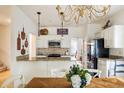 Bright eat-in kitchen with granite countertops and white cabinetry at 1440 Vinery Ave, Cumming, GA 30041