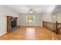 Living room featuring hardwood floors, a brick fireplace and loft view at 3335 Pinta Way, Douglasville, GA 30135