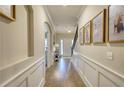 Long hallway with hardwood floors and wall-mounted pictures at 340 New Alcovy Rd, Social Circle, GA 30025