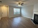 Spacious living room featuring a fireplace and wood-look floors at 268 Springbottom Dr, Lawrenceville, GA 30046