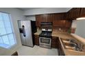 Clean kitchen with stainless steel appliances and wood cabinets at 6628 Wellington Sq, Norcross, GA 30093