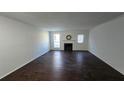 Living room with fireplace and dark brown wood-look flooring at 6628 Wellington Sq, Norcross, GA 30093