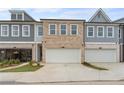 Three-unit townhouse building with gray and brick facade at 1032 Rose Dr, Marietta, GA 30060