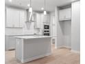 Modern kitchen with island, stainless steel appliances, and light gray cabinets at 1032 Rose Dr, Marietta, GA 30060